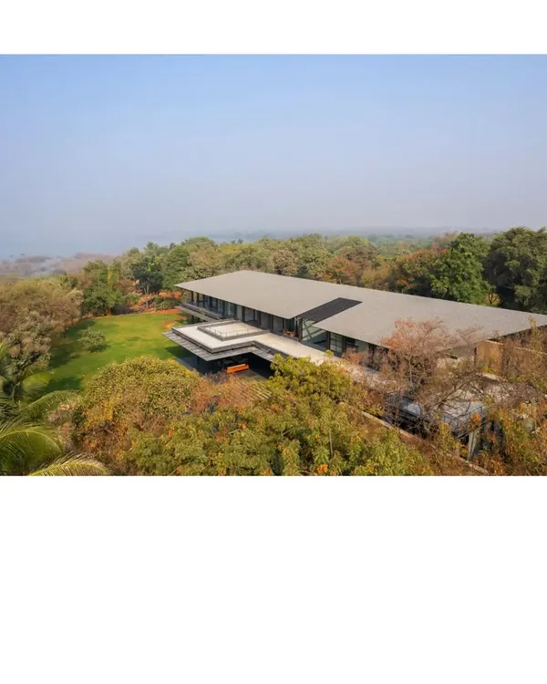 An aerial view of the Lakeshore house, nestled within its 50 acre site on Lake Osman Sagar. The structure is designed to be a subtle insertion into the geological history of the place, respecting the rocks and trees that were there long before us.