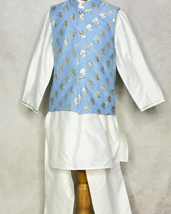 A classic white kurta pajama set gets an upgrade with this powder blue floral brocade Nehru jacket. It's a smart and stylish look for any young gentleman.