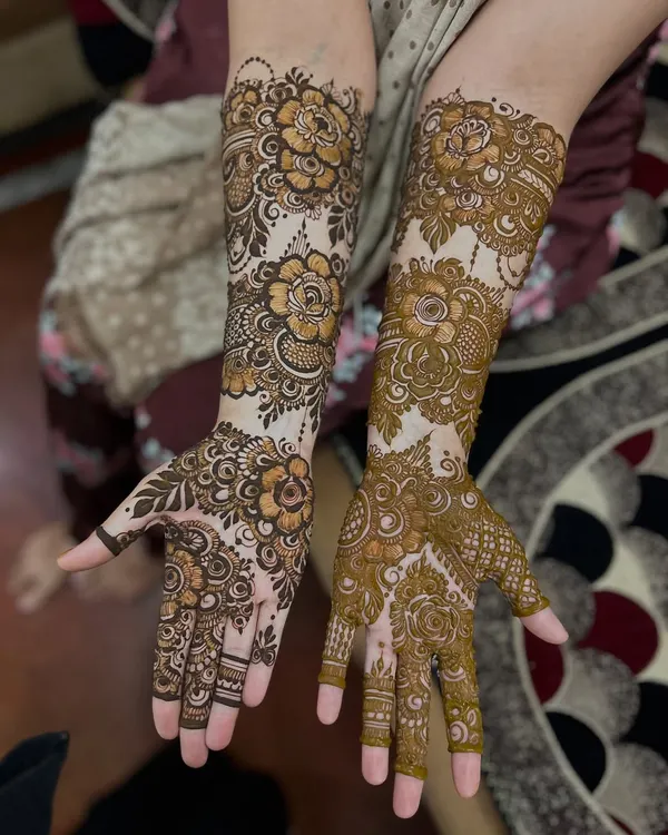 A stunning floral design that covers the hands and forearms. The use of negative space makes the flowers and leaves really stand out.