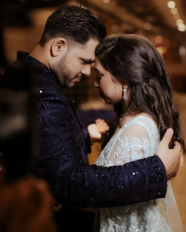 A close-up of the couple in a tender embrace, their foreheads touching. This intimate framing shuts out the world, focusing solely on their connection and the quiet promise they share.