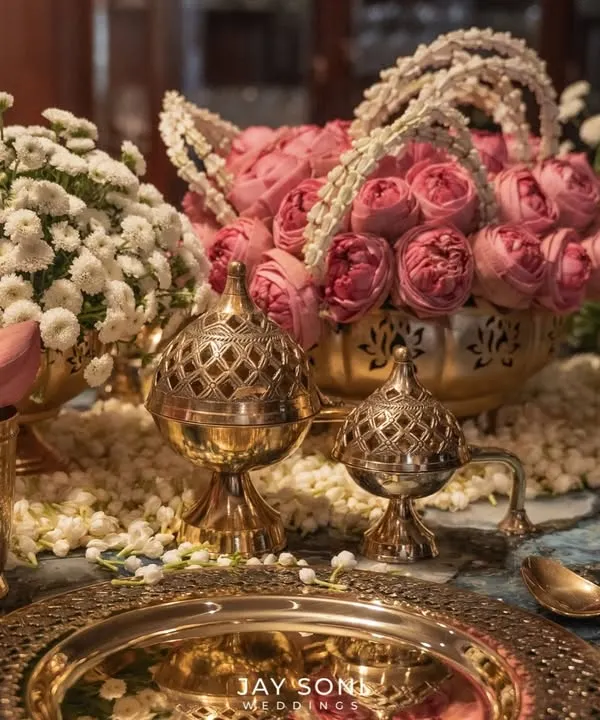 Every detail matters. This close-up shows the intricate craftsmanship of a traditional table setting, with embossed brass plates, lotus bud accents, and ornate incense holders, all contributing to a feeling of royal elegance.