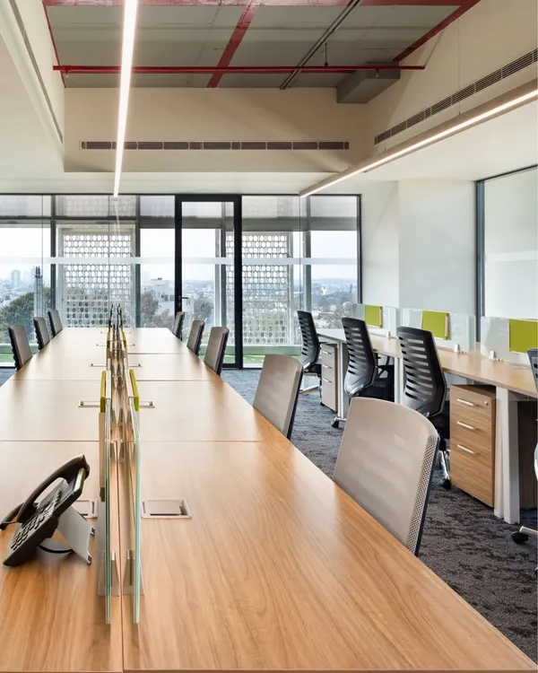 For the APT office in New Delhi, we prioritized natural light and open sightlines. The long communal workstations are positioned to give employees expansive views, while low partitions maintain a sense of personal space without sacrificing the open, collaborative feel.