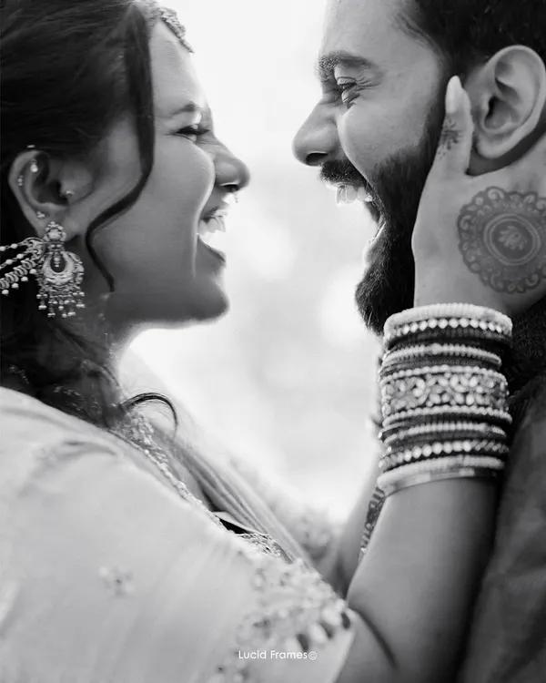 A moment of pure, uninhibited laughter between a couple. Black and white enhances the raw emotion and connection in this candid shot.