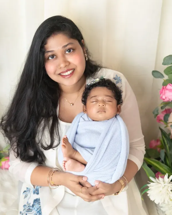 There's nothing like a mother's love. This classic portrait captures a new mom holding her sleeping baby, a timeless image of their special bond.