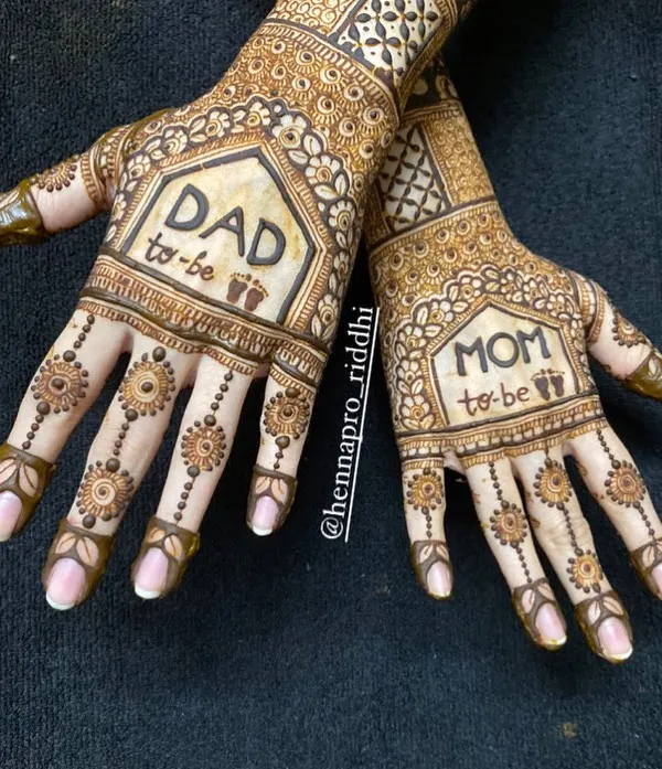 Matching henna for the parents-to-be is such a sweet idea. This design features 'Mom to be' and 'Dad to be' with tiny baby footprints, creating a beautiful memory of this special time.