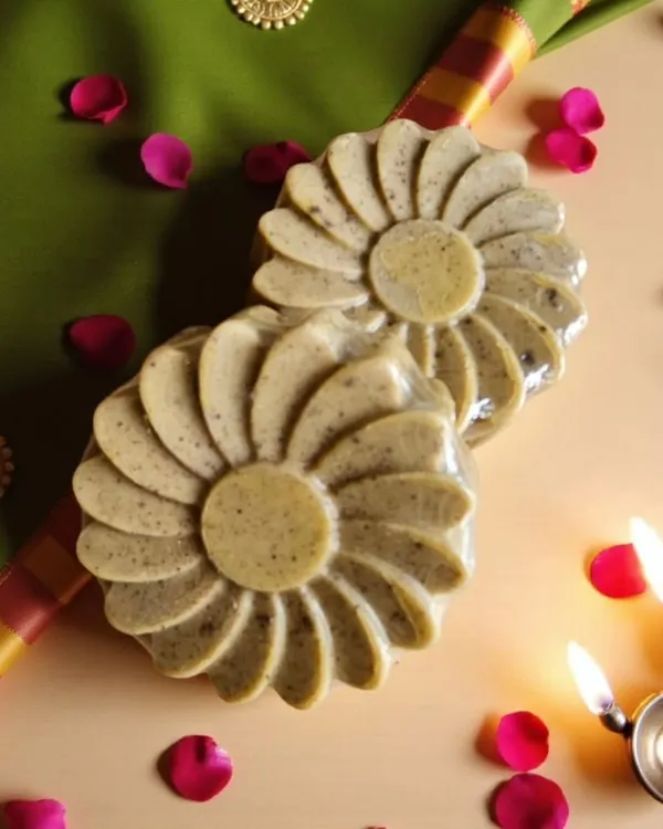 My Abhyangasnan Ubtan Soap, beautifully set for a festive ritual. It's crafted with a blend of turmeric, sandalwood, neem, and rose to detoxify and brighten your skin naturally.