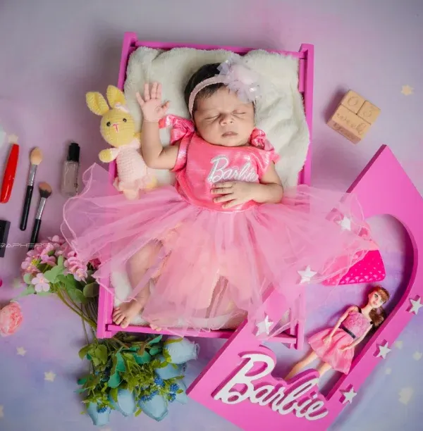 Your little one is a real-life doll. I had so much fun creating this Barbie-themed setup, complete with a doll box and tiny accessories for a playful and unique portrait.