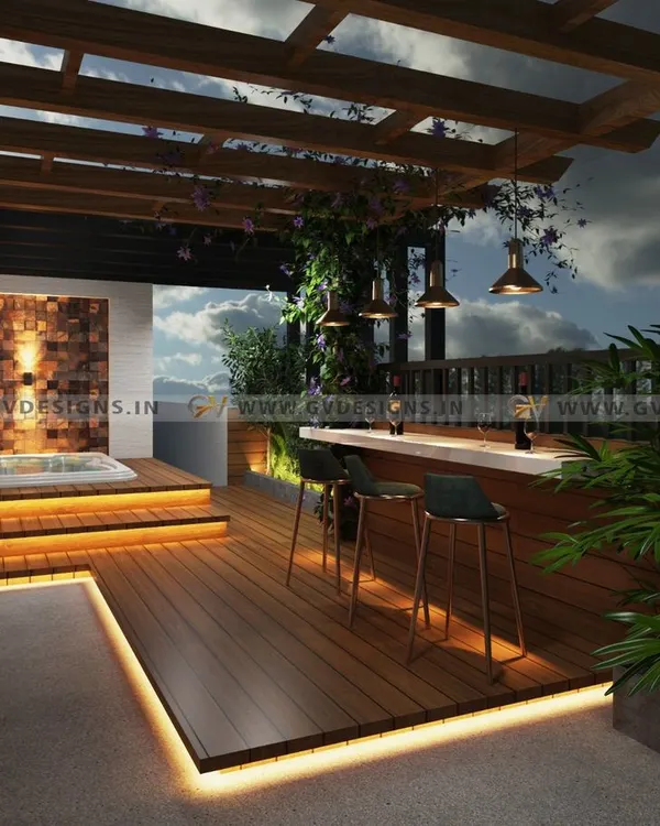A complete view of a modern terrace transformation. This project combines entertainment and relaxation with a dedicated bar area under a pergola, a raised jacuzzi deck, and multiple levels of wooden flooring, all surrounded by lush greenery for privacy and ambiance.