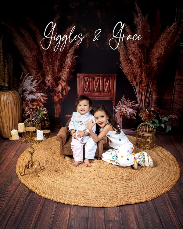 Giggles and grace. This portrait of two sisters captures the sweet and gentle love they share in our warm, rustic-themed setup.
