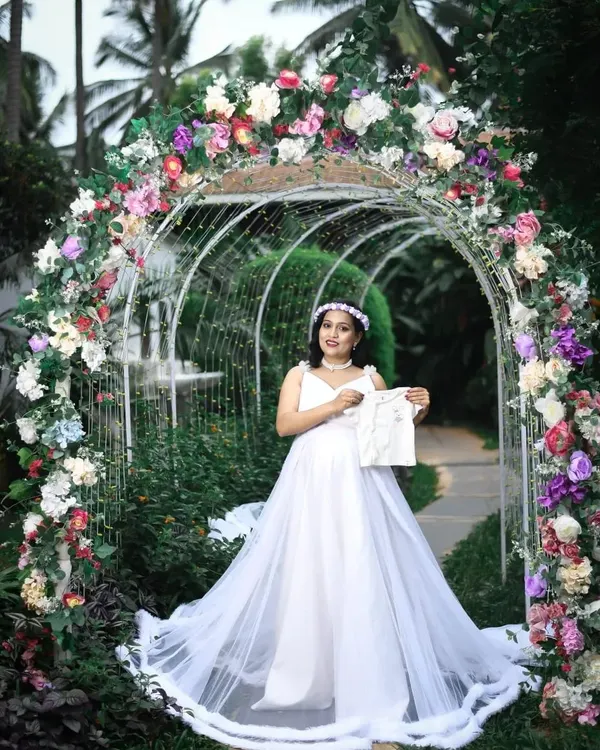 This is the complete fairytale experience I create for my maternity clients. The package for this look includes the flowing white rental gown, a delicate floral crown, professional makeup, and hairstyling, all set against a beautiful floral arch to perfectly capture the moment.