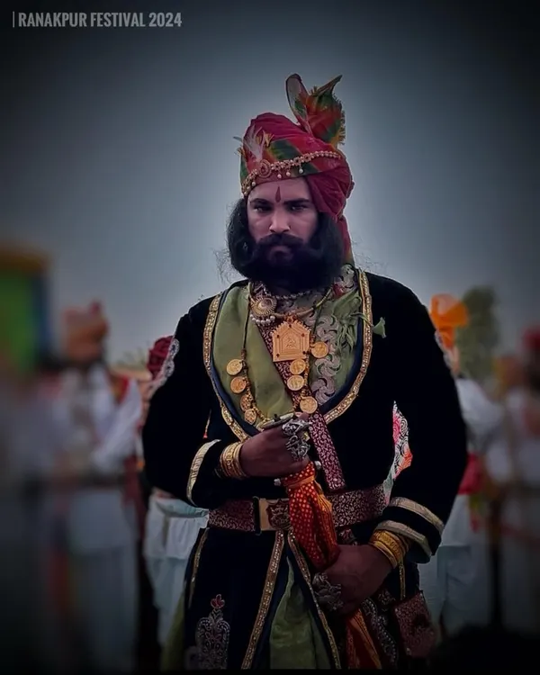 A proud Rajasthani man in traditional attire and a magnificent turban at the Ranakpur Festival, embodying the region's regal heritage.