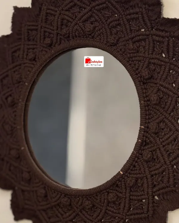 This decorative wall mirror is framed with an intricate, hand-knotted macrame design. Shown here in a rich brown, it adds a beautiful, textural element to any wall and is available at a special discounted price.