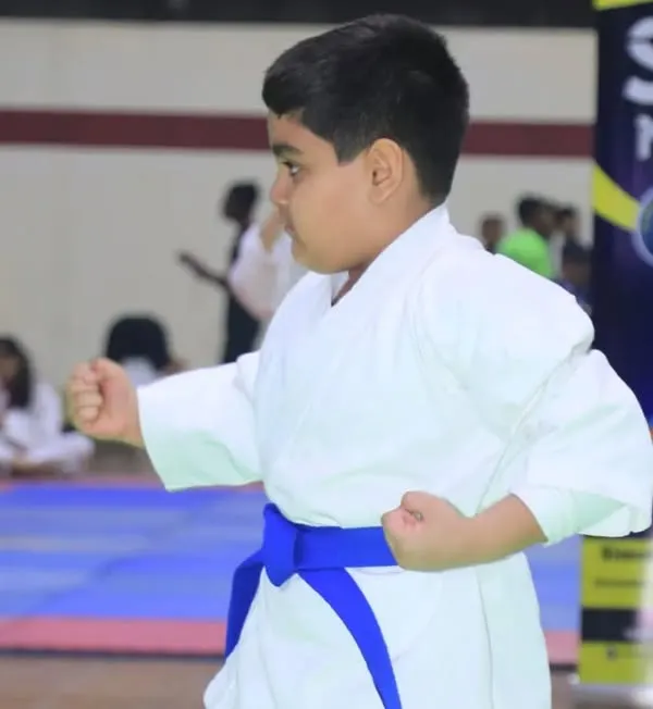 A young student demonstrates a perfect karate stance during a competition. We focus on teaching proper form and discipline from the very beginning.