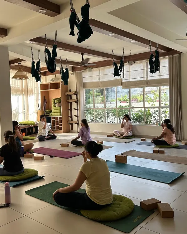 A daytime class in our sunlit studio. The space is intentionally designed to be bright, airy, and calming, providing a peaceful environment for you to focus on your practice of asana, pranayama, and meditation.