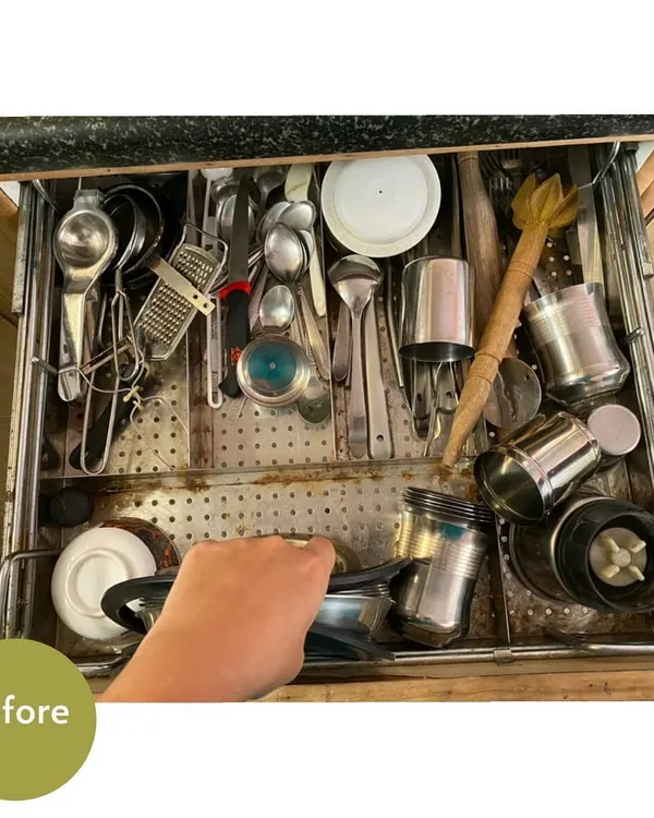 A "before" shot of a typical kitchen cutlery drawer. It's a jumble of spoons, ladles, and other tools, making it hard to find what you're looking for.