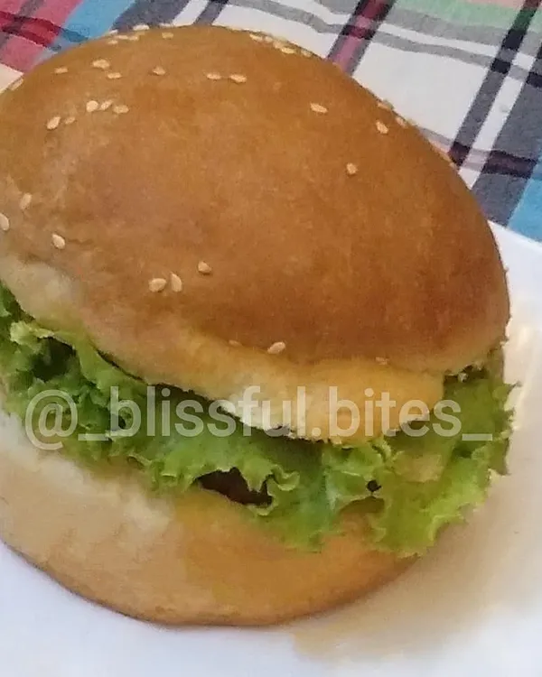 A simple and delicious homemade Zinger Burger, with a crispy chicken patty and fresh lettuce tucked into a soft, sesame-topped bun.