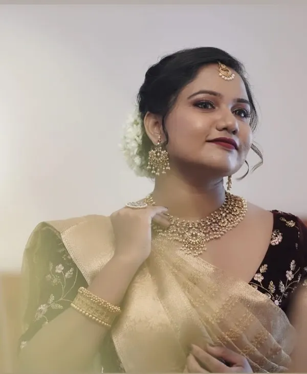 This bride chose a very elegant and classic look for her big day. Her makeup is subtle yet defining, with a classic red lip and a soft updo adorned with fresh white flowers.