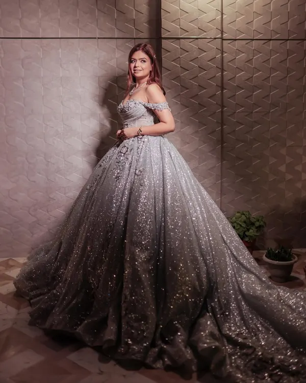 The full view of my fairytale silver ball gown. The voluminous skirt is covered in sequins that catch the light beautifully, creating a magical effect for any grand entrance. This is the ultimate princess gown for your special day.