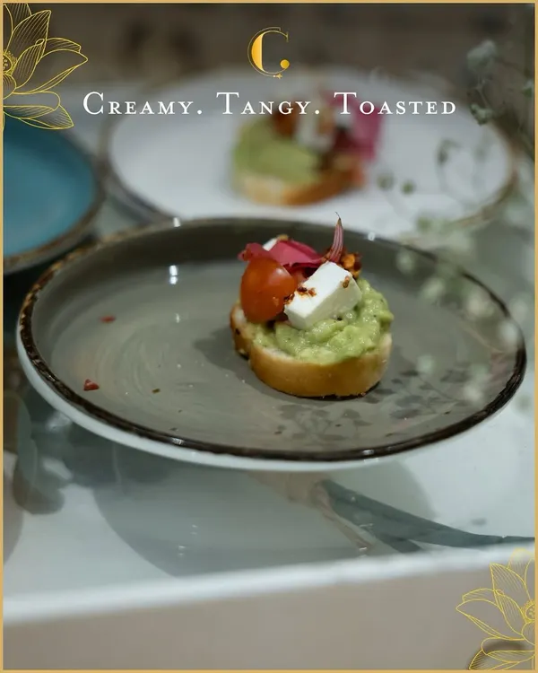 A modern classic, our avocado cream cheese toast is topped with fresh cherry tomato and a cube of paneer. It's a creamy, tangy, and refreshing bite perfect for high-tea or as a welcome appetizer.