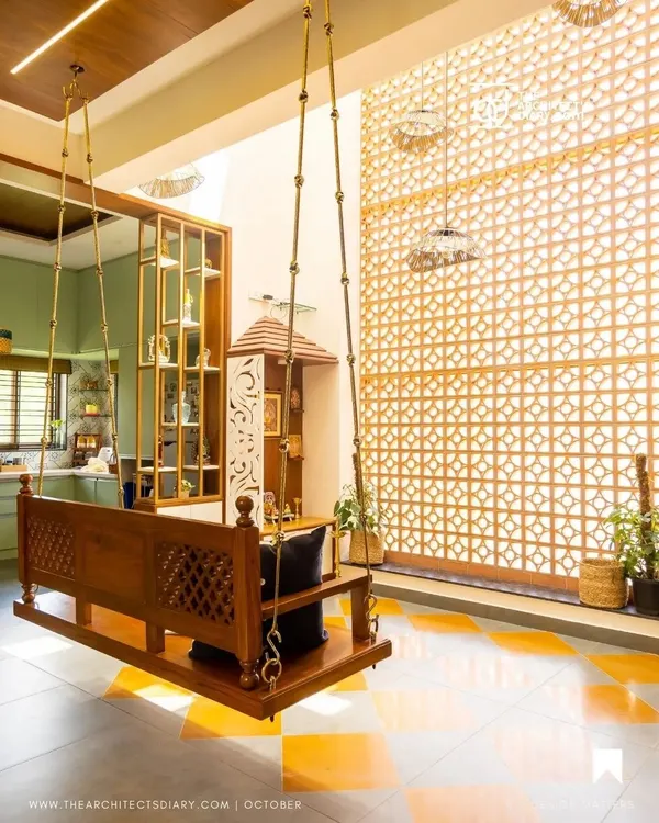 A traditional wooden swing (jhula) is the heart of this living space, set against a backdrop of a double-height jali screen and Jaisalmer marble inlay flooring. This is the essence of my Indian Modern design philosophy.