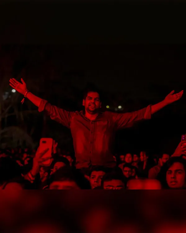 One fan, arms outstretched, feeling the music. This is the personal, almost spiritual connection we aim to create at every concert.
