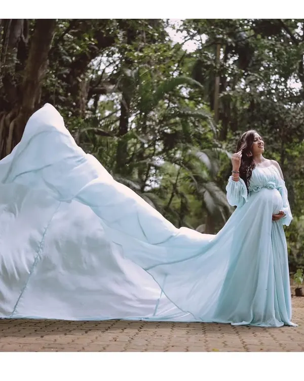 This is what fairytale moments are made of. My powder blue flying train gown creates breathtaking, dramatic photos that you will cherish forever. It's perfect for an outdoor maternity shoot where the fabric can catch the wind.