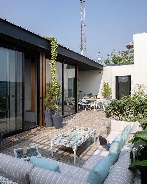The terrace garden for a Delhi executive suite serves as a lush, open-air extension of the office. It provides a serene space for informal meetings or quiet contemplation during a hectic workday.