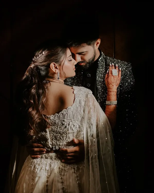 An intimate and moody portrait of a couple on their Sangeet night. I use shadows and focused light to create these dramatic, fine art photographs.