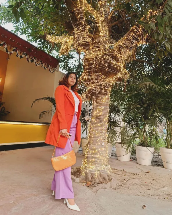 Celebrating the new year with a colorful and confident outfit. I paired bold purple wide-leg pants with a vibrant orange coat, grounded by a simple white tee and heels. This is what I mean by slaying with style.