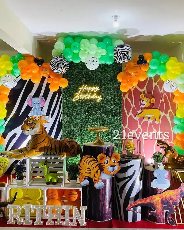 A full view of a vibrant jungle safari theme, complete with a neon sign, zebra and giraffe print backdrops, and plenty of animal props. This is one of my most detailed and budget-friendly packages.
