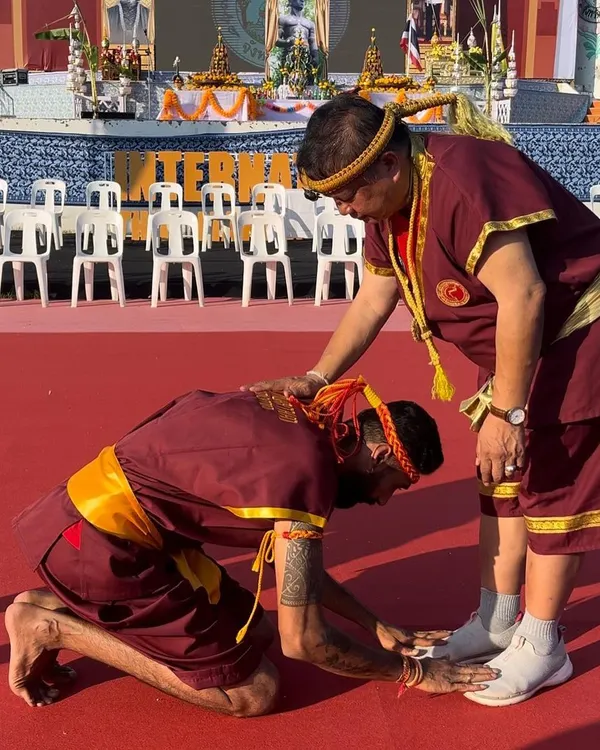Paying my respects to my master, my godfather. The Wai Kru ceremony is about honoring your teachers. I am kneeling before my guru in Thailand.