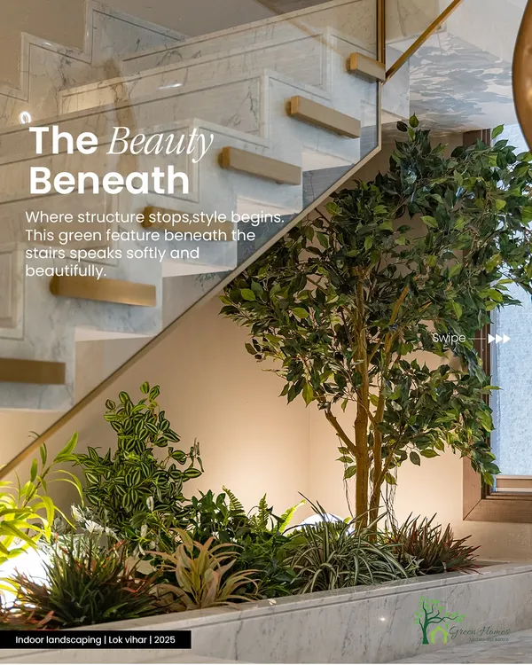 A lush arrangement of faux greenery and a statement tree fills the space under a modern staircase. This design uses backlighting to create depth and highlight the varied leaf shapes, turning dead space into a beautiful feature.