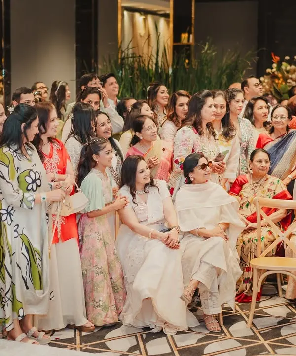 When the best moments come from people, not plans. This shot captures the joy of the guests as they watch the sangeet performances, completely immersed in the celebration.