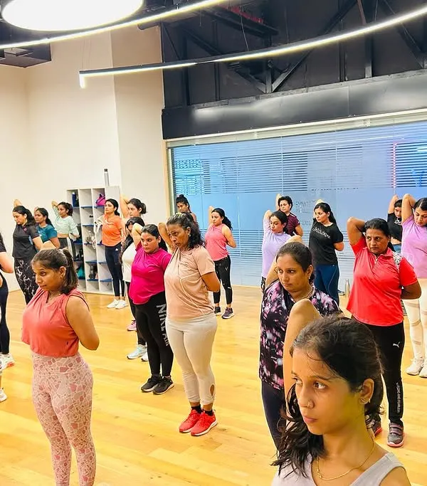 A wide shot of our vibrant group class at Bhartiya Mall. You can see the focus and energy as we move through a strength and conditioning routine together in a spacious, modern studio.