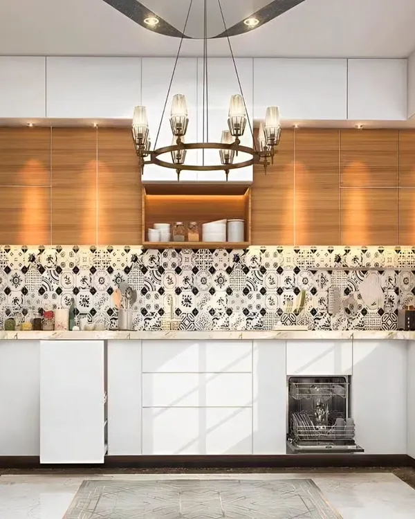 We designed this stunning U-shaped kitchen with a bold black-and-white patterned tile backsplash. The white handleless cabinets and drawers are contrasted with warm wood overhead units, and the space includes an integrated dishwasher and oven.