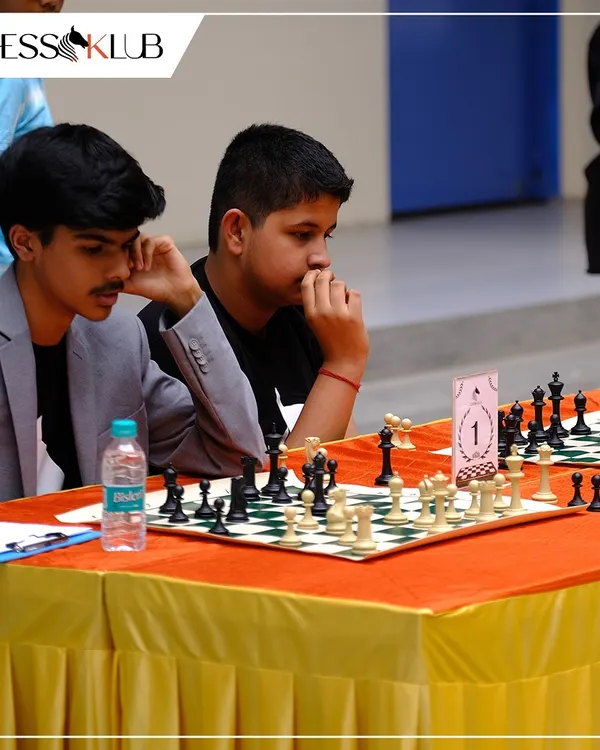 Deep in concentration during a simultaneous chess match at our Chess Carnival. Events like these challenge our students to think on their feet against experienced players.