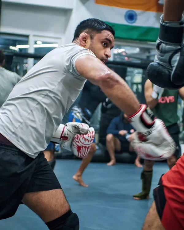 A fighter throws a sharp cross during a sparring session, with the Indian flag in the background. We are proud to train and develop homegrown talent to compete on the world stage.