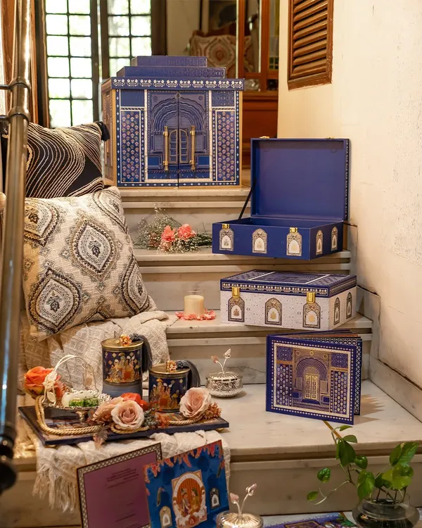 This is a complete suite from the Golden Dunes collection, displayed on a staircase to show its various elements. It includes the main architectural box, smaller favor boxes, and coordinated gift items, all designed to create a cohesive royal narrative.