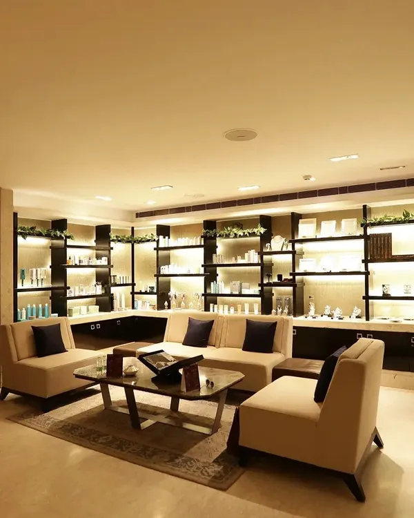 Our sophisticated lounge area, featuring plush seating and beautifully lit displays of premium beauty products. This is a space where you can unwind before or after your treatment in absolute comfort.