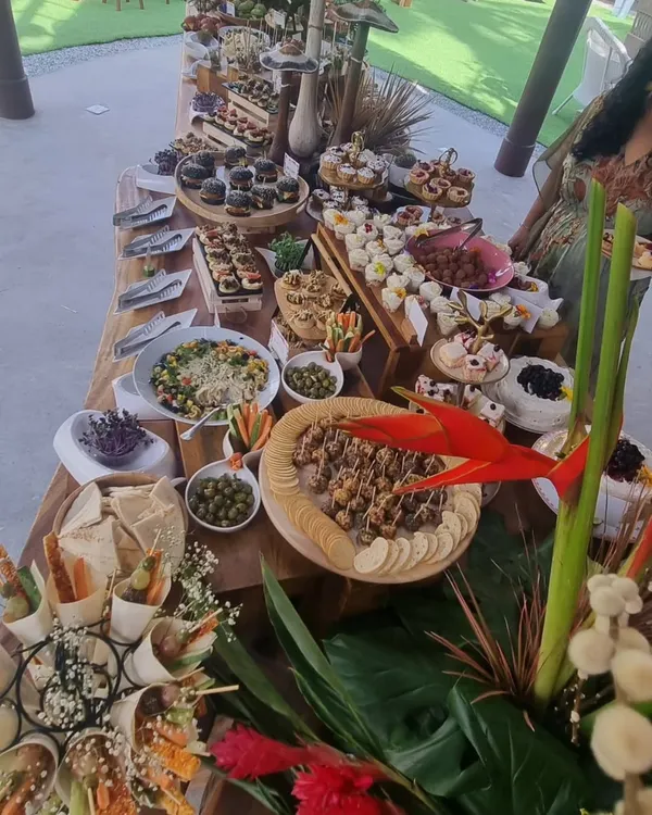 We believe every event deserves a stunning centerpiece. This expansive grazing table, created for a grand launch, showcases our passion for abundance and artistry, featuring a curated selection of gourmet bites, fresh produce, and beautiful floral arrangements.