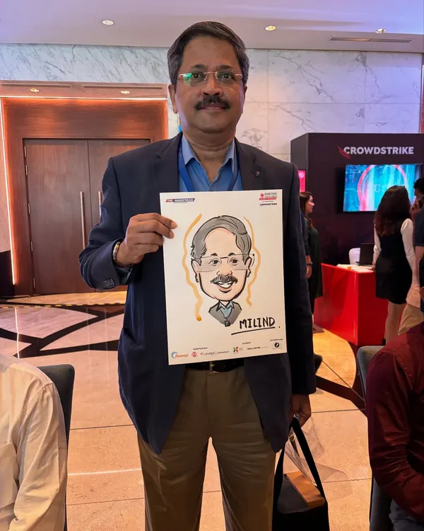 A guest at the Jio World Convention with his caricature. The drawing paper is co-branded with the event sponsor's logo, making it a great marketing tool.