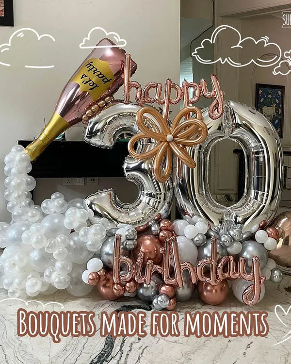 Bouquets made for moments. This extravagant 30th birthday balloon arrangement features a popping champagne bottle, large silver number balloons, and a chic color scheme of silver, white, and rose gold.