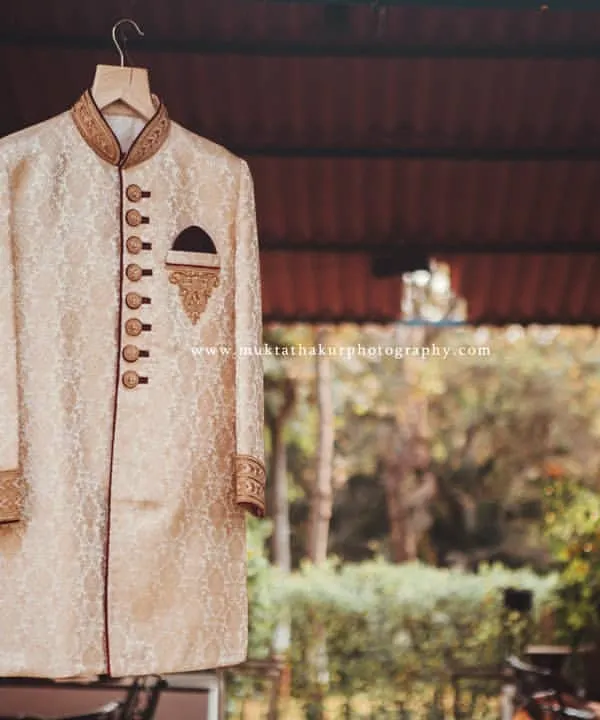 The groom's sherwani, hanging in anticipation of the big moment. I take care to photograph the wedding attire in a way that feels as grand as the day itself.
