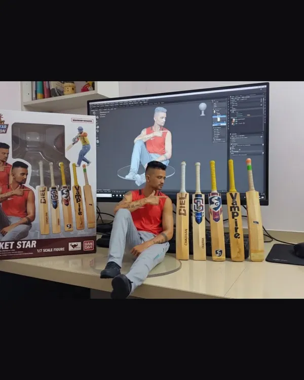This is a part of my collection. I am sitting with my custom 3D model, my action figure, and a lineup of my favorite cricket bats from brands like SG, SS, and Vampire.