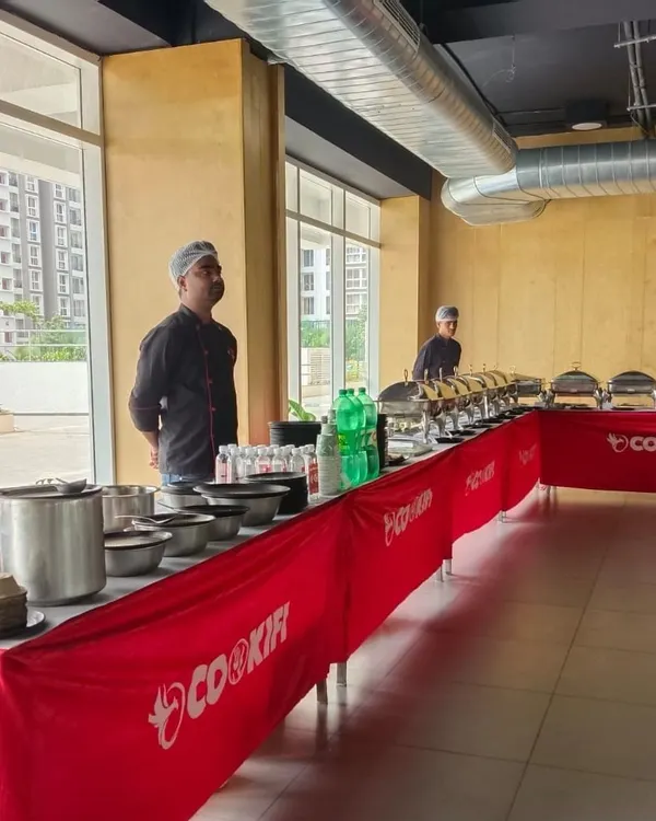 Our team setting up the buffet in a modern, well-lit clubhouse. We ensure our setup is clean, professional, and ready well before your guests arrive.