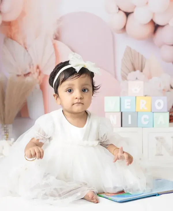 Celebrating one year with a beautiful pastel balloon setup. These milestone sessions are designed to be soft, dreamy, and perfect for a first birthday.