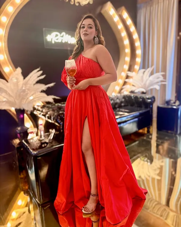 A red dress and a glass of wine. A perfect combination for a winter evening event.