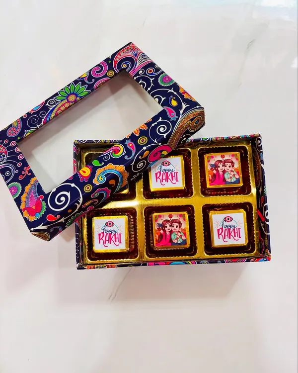 A box of my special Rakhi chocolates with custom-printed wrappers. This box features a beautiful paisley design and a clear window to see the festive treats inside, perfect for gifting to a brother or sister.