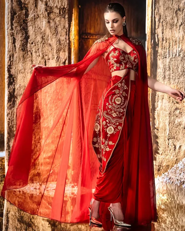 When light kisses crimson. This shot was framed to capture the motion of the sheer cape, the detail of the embroidery, and the elegance of the pose, all suspended in a single moment.