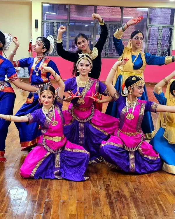 A group of our Bharatanatyam students in full traditional costume, ready for a performance. We emphasize stage readiness, including costumes and makeup.